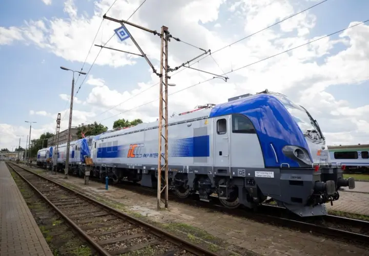 Nowy lubuszanin pociąg PKP Intercity stoi na torach pod błękitnym niebem.