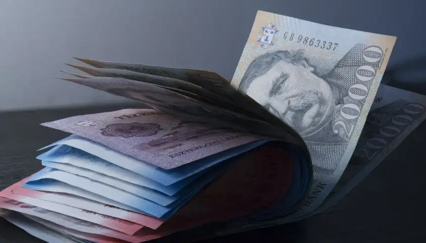 Stos banknotów, w tym 20 000 forintów, symbolizuje walutę w Budapeszcie.